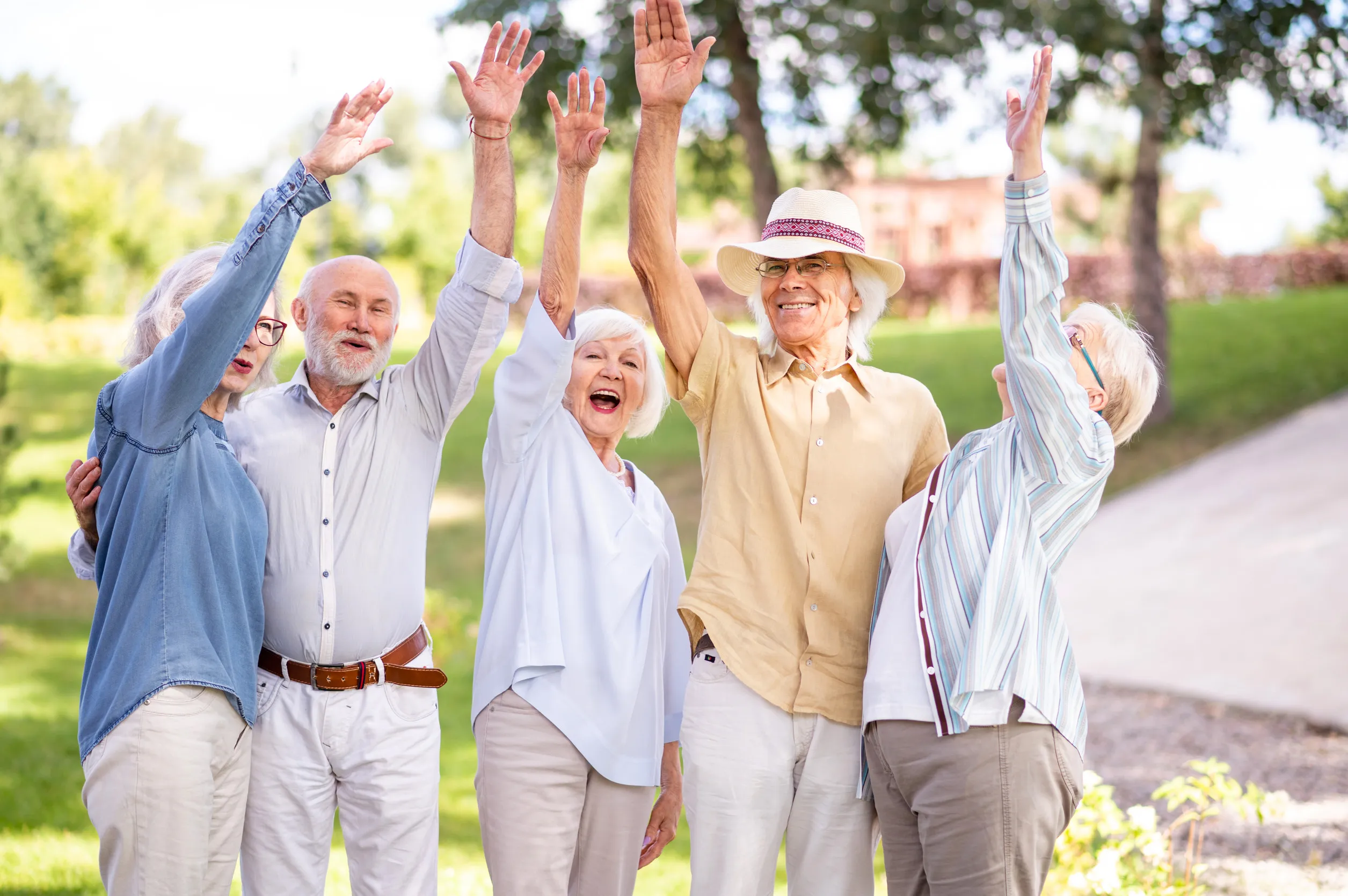 Group of happy elderly people bonding outdoors at the park